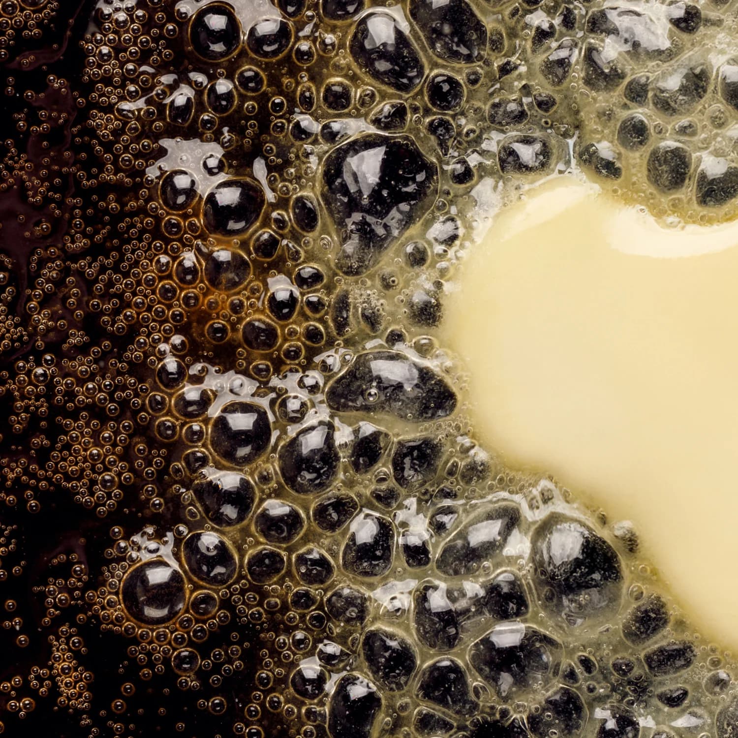 Butter foaming in a dark pan