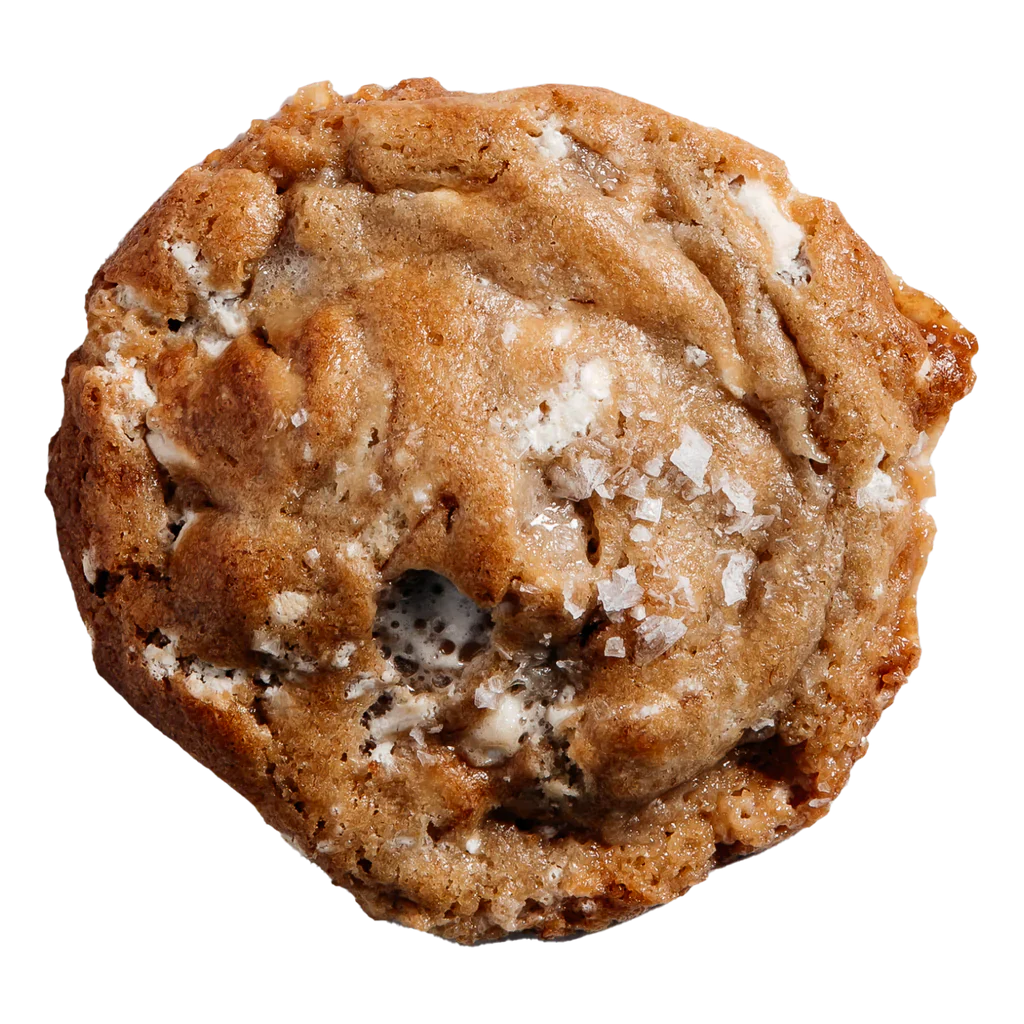 A single cookie with visible chunks of banana, marshmallows, and white chocolate chips, sprinkled with sugar on top.