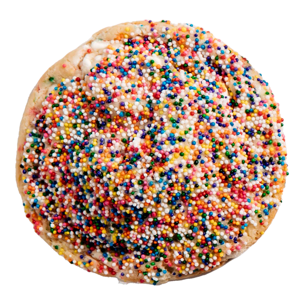 A cookie topped with multicolored sprinkles and a drizzle of vanilla frosting.