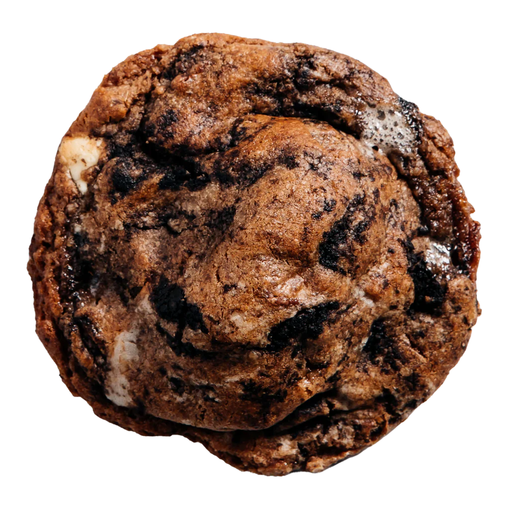 A single chocolate cookie with visible chunks of Oreo and malted milk balls.